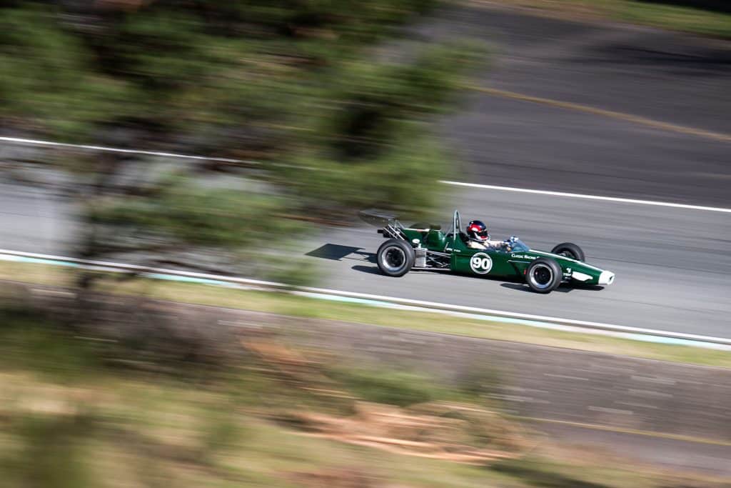 a green race car on a road